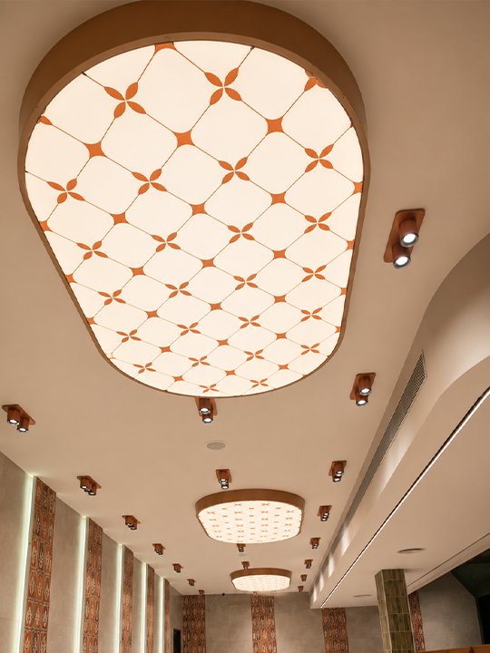 Stained glass style backlit ceiling dome in a cinema lobby — cost and value benefits